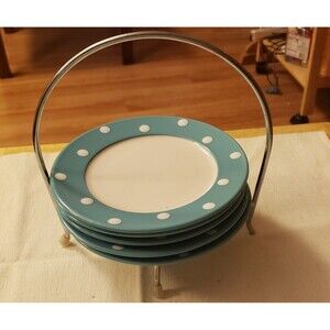 Five 6”D SIGNATURE DESSERT PLATES CALLED DOT AND A METAL CADDY. EXCELLENT COND
